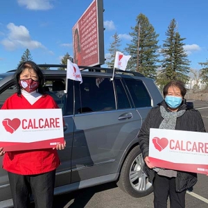 Nurses outside hold CalCare signs
