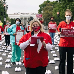 Nurses outside The White House holding signs calling for nurse, patient, and public safety