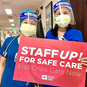 Seton Medical Center nurses holding sign "Staff up for safe care: End crisis care now"
