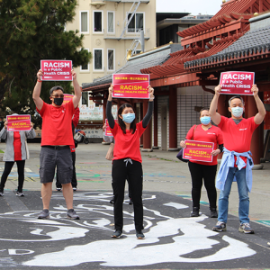 Nurses hold signs "Racism is a Public Health Crisis"