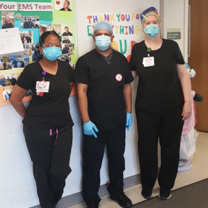 3 masked nurses in hallway