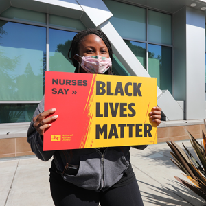 Nurse hold signs "Black Lives Matter"