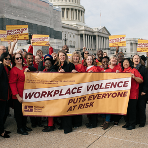 Nurses hold signs calling for Workplace Violence Prevention"