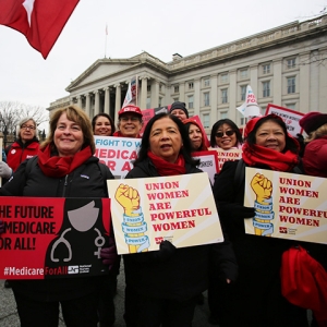 Group of nurses in march holding signs "Union women are powerful women"