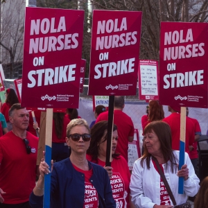 UMC nurses hold "Nola nurses on strike!" signs during strike.