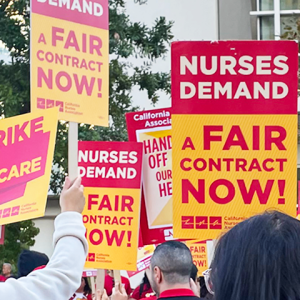Nurses holding signs "Nurses demand a fair contract now!" 
