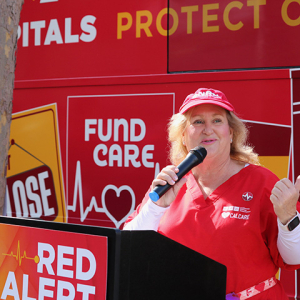 Sandy Reding, RN, at podium in front of bus