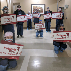 Arcadia health care workers hold signs "Patients First"