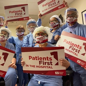 Nurses holding signs: "Patients First in the hospital"