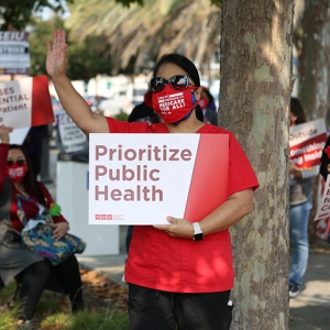 Nurse hold signs "Prioritize public health"