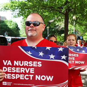 VA nurses marching with signs "VA nurses deserve respect now"
