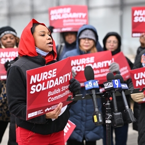Nurses holding press conference holding signs "Nurse Solidarity"
