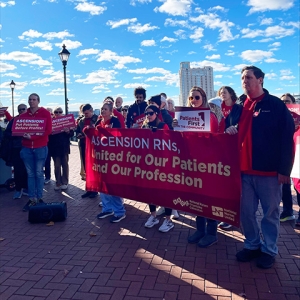 Nurses outside holding banner "Ascension RNs, United for our Patients and our Profession"