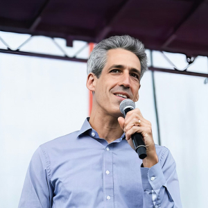 Daniel Biss holding microphone