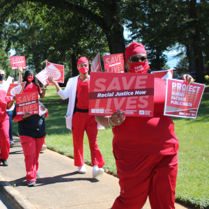 Nurses holds signs "Racial Justice Now"