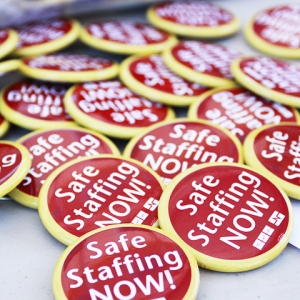 Pile of buttons which say "Safe staffing NOW!"