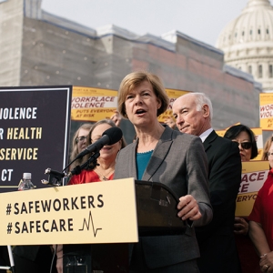 Senator Tammy Baldwin at podium outside Capitol Building