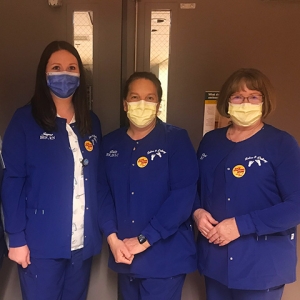 Four nurses inside hospital standing side-by-side