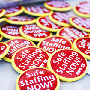 Pile of "Safe Staffing Now" buttons