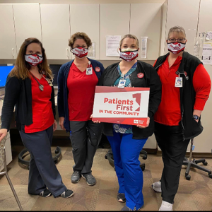 Enloe Medical Center RNs hold sign "Patients First in the Community"