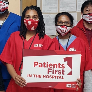 Nurses holding sign: "Patients First in the hospital"