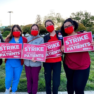 Four nurses hold signs "We will strike for our patients"