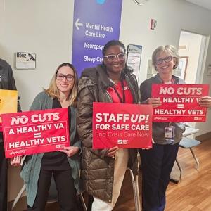 Nurses in hallway holding signs "No Cuts: A Healthy VA = Healthy Vets"