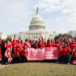Large group of nurses outside capitol building, NNU logo