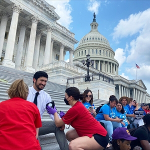 Rep. Casar being treated by an RN on steps of capitol