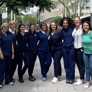 Group of nurses arm-in-arm outside