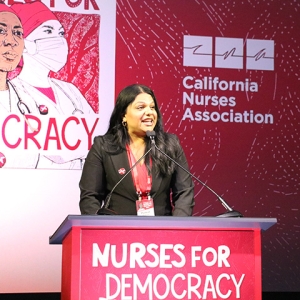 Puneet Maharaj at podium on stage