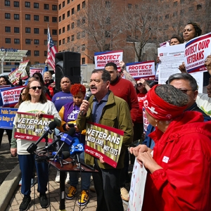 Health care workers and Congressman Chuy Garcia holding a press conference outside hospital