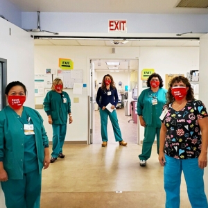 Five nurses in hospital hallway