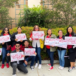 Group of nurses outside holding signs "Nurses Support WGA"