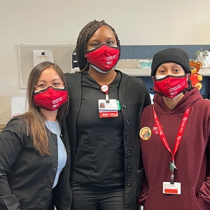 Three nurses wearing masks that read "Staff up for safe care"