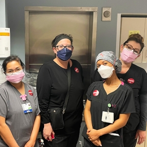 Group of five nurses inside hospital