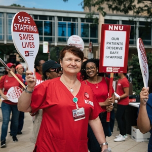 Nurses picketing outside hospital holding signs calling for safe staffing