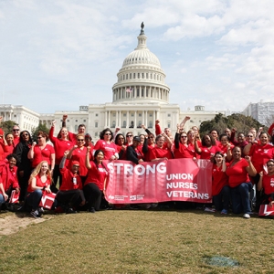 Large group of nurses outside Capitol building holding banner "Strong Union, Nurses, Veterans"