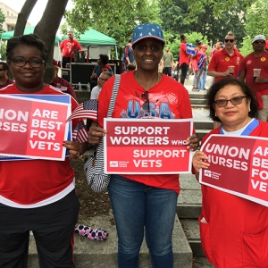 3 nurses hold signs "Support Workers who Support Vets"