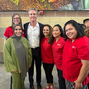 Five nurses standing with Governor Gavin Newsom