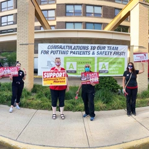 Nurses outside Community First Medical Center hold signs calling for safety