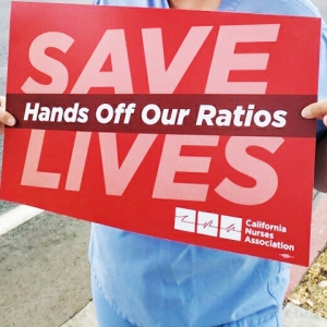 Sign: "Save lives, hands off our ratios"