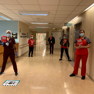 Nurses in Alta Bates holding signs "Save Lives"