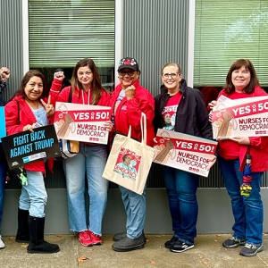 Nurses holding signs "Yes on 50: Nurses for Democracy"