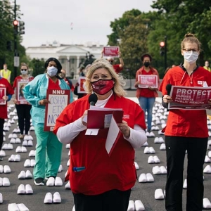 Nurses outside The White House holding signs calling for nurse, patient, and public safety