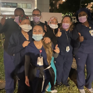 Group of nurses outside givingn thumbs up