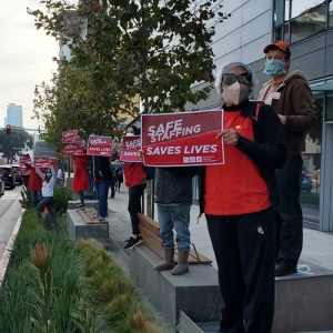 Nurses hold signs calling for safe staffing