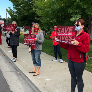 Nurses holds signs for safe staffing