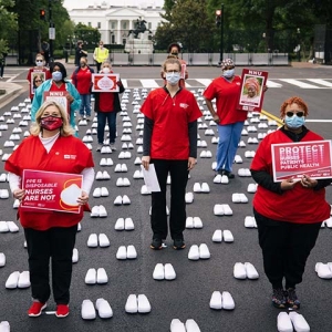 Nurses outside The White House holding signs calling for nurse, patient, and public safety