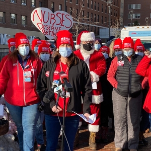 Group of nurses giving press conference with Santa